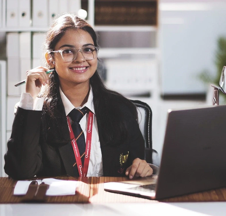 Quantum University student working on a laptop